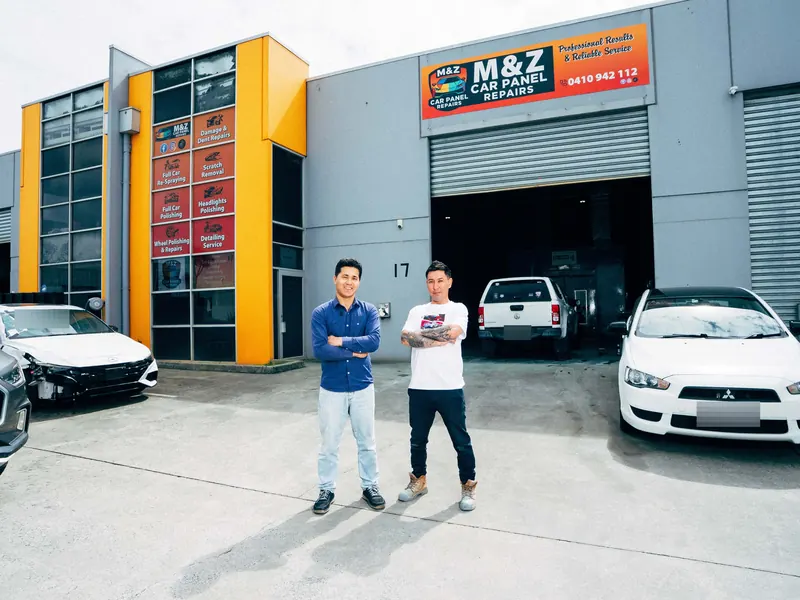 The M&Z team outside the workshop with cars in for repair